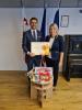 Ambassador P. Mikyska and Deputy Head of Mission J. Gašparíková with painting supplies and Honourable Mention 